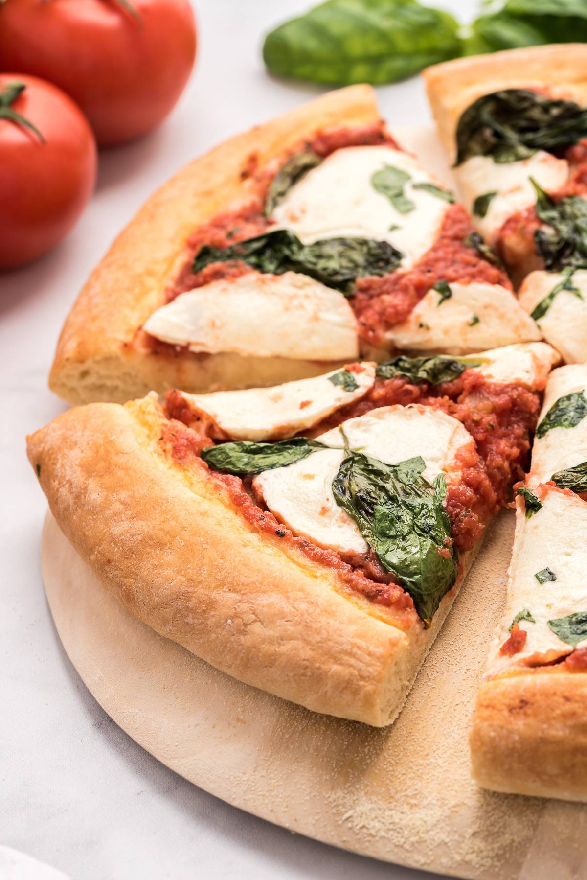 Slices of pizza on a wooden cutting board.