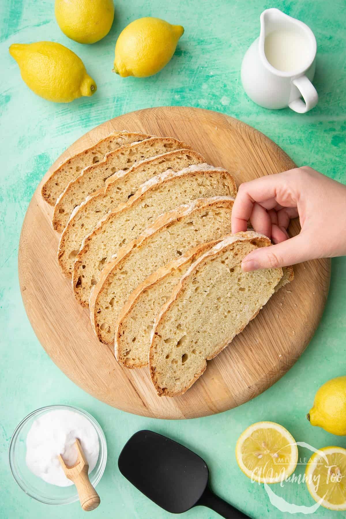 Slices of soda bread on a brown cutting board.