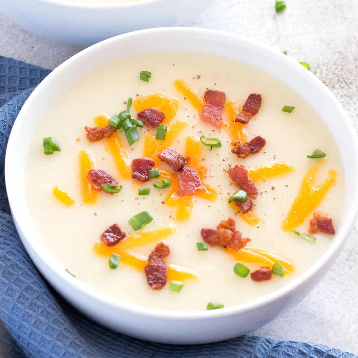 Homemade potato soup from scratch in white bowl.