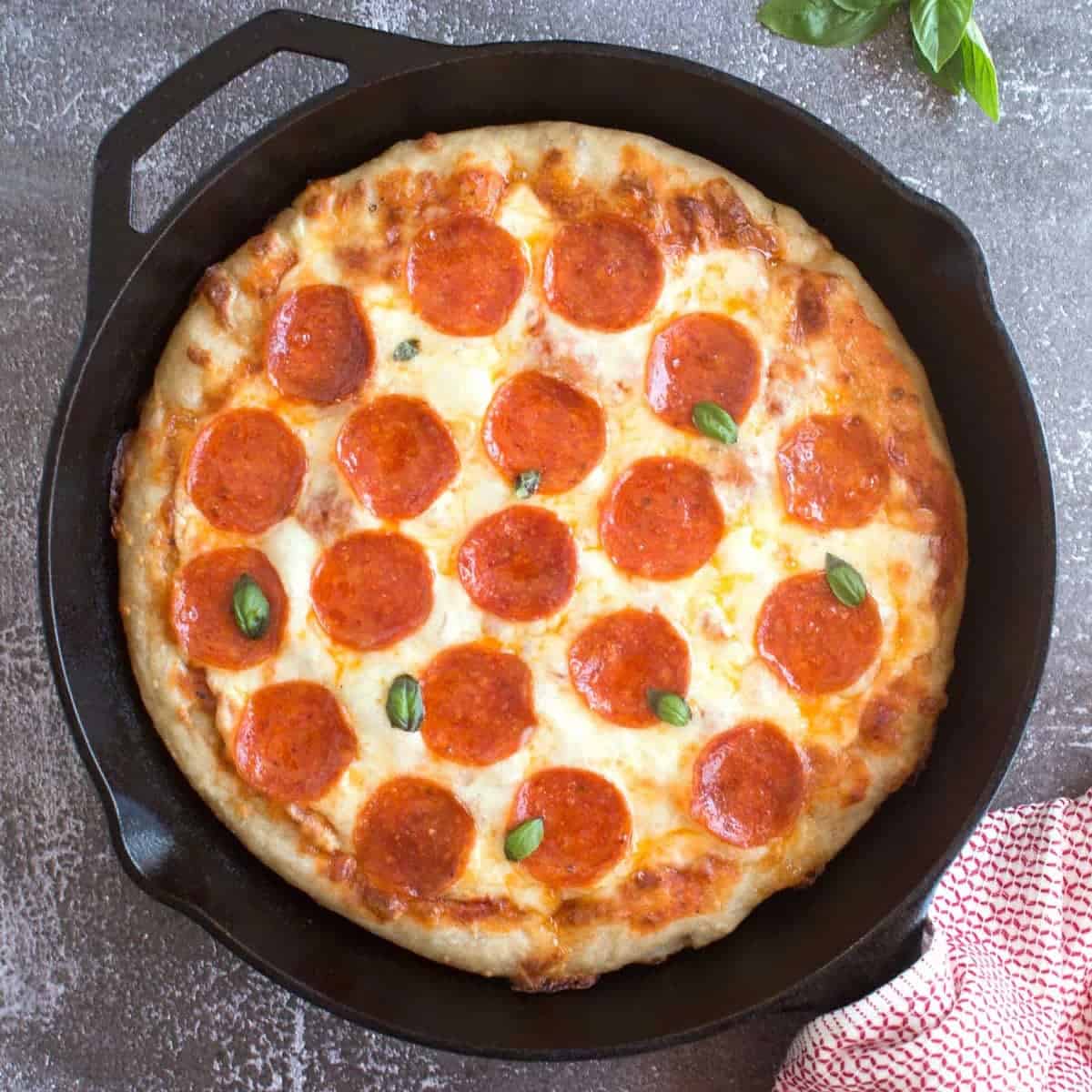 Pepperoni pizza in a cast iron skillet.