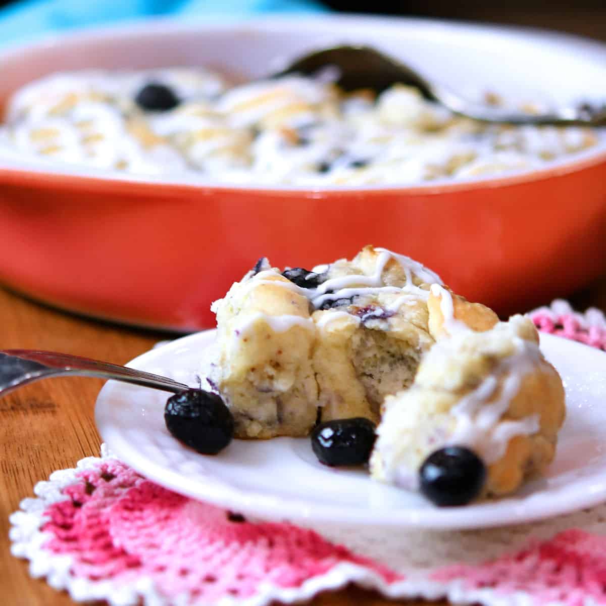 Blueberry biscuit on a plate with a fork.