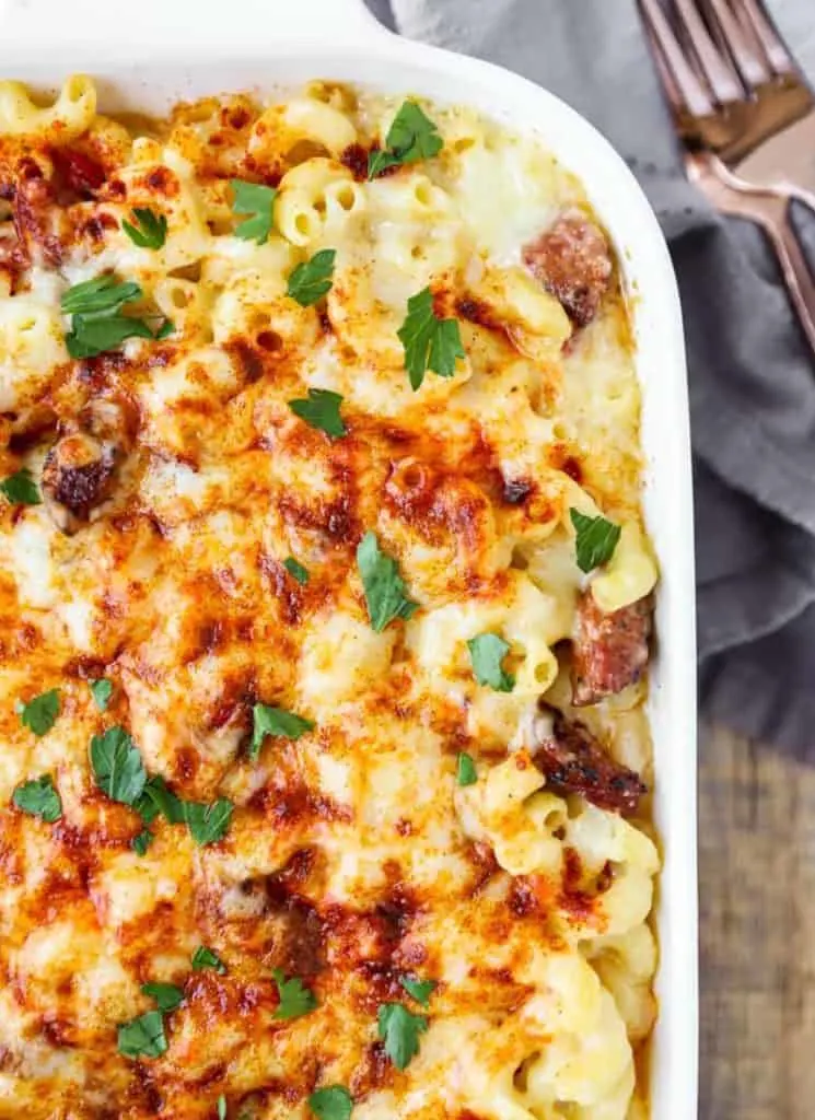 Cajun mac and cheese in a casserole dish with a fork.