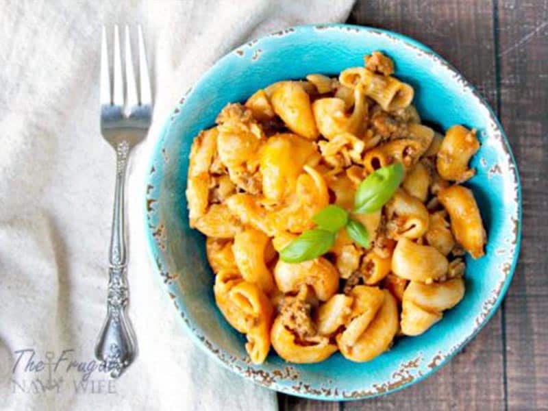 Cheeseburger mac and cheese on a blue plate with a fork.