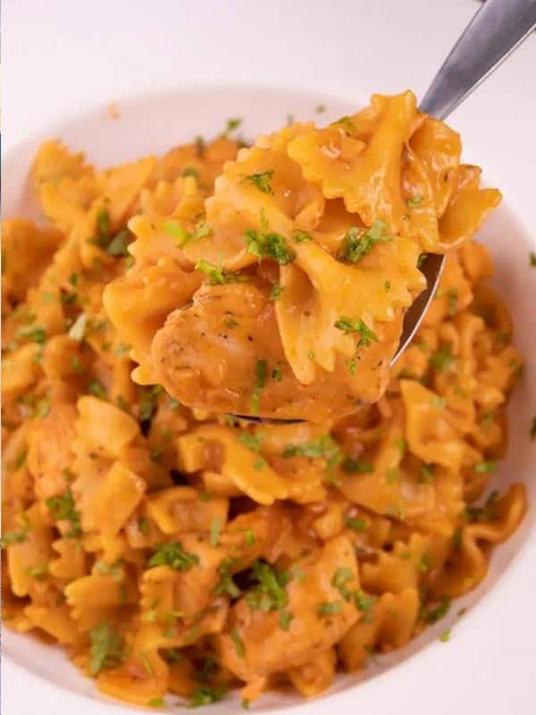 A quick and easy chicken parmesan pasta in a white bowl.