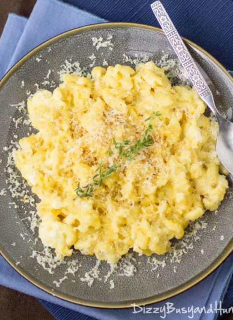 Slow cooker macaroni and cheese with bread crumbs on a gray plate.