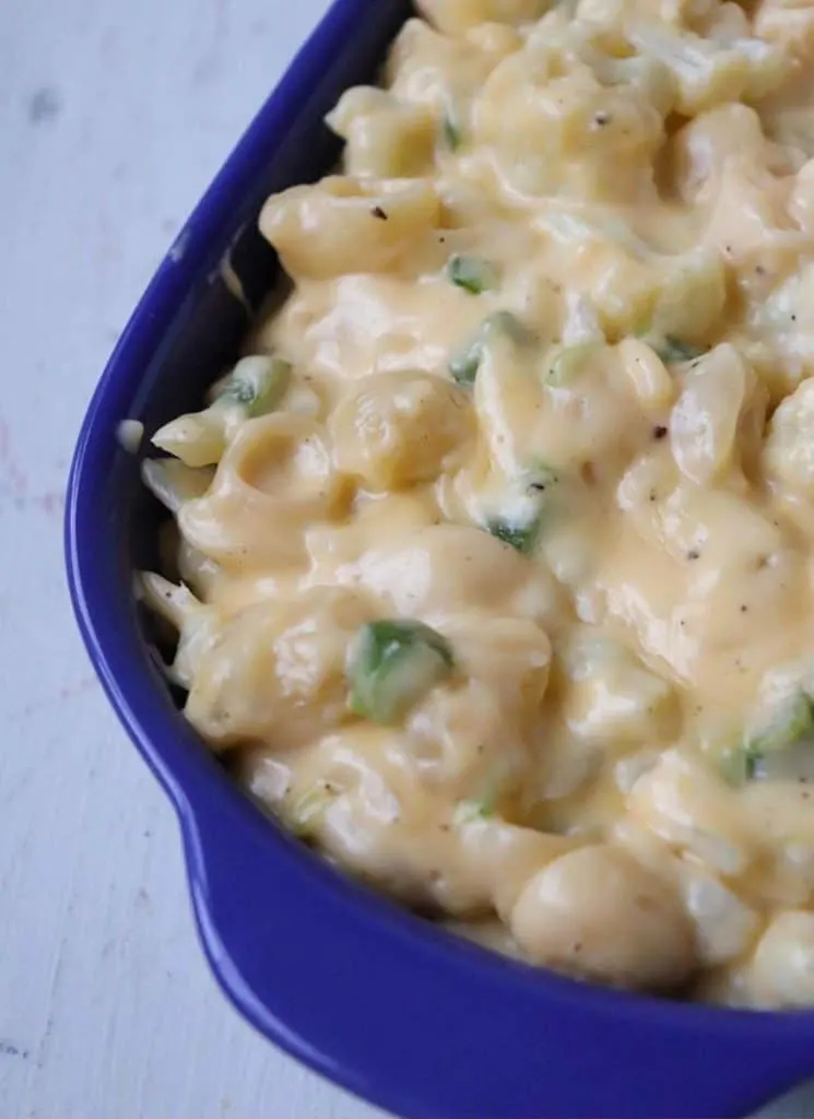 Spicy cauliflower mac and cheese in blue casserole dish.