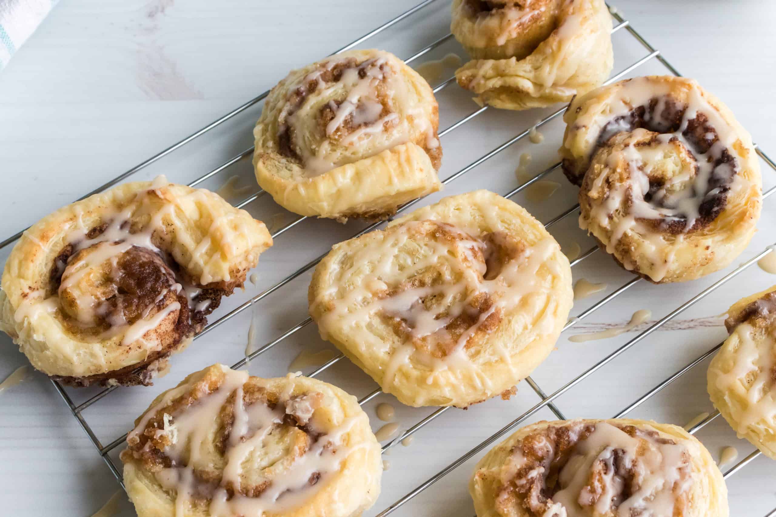 Cinnamon rolls on a cooling rack.