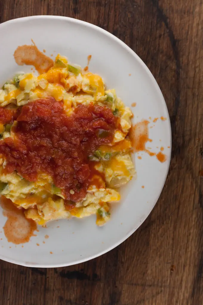 Easy ranchero eggs scramble on a white plate.