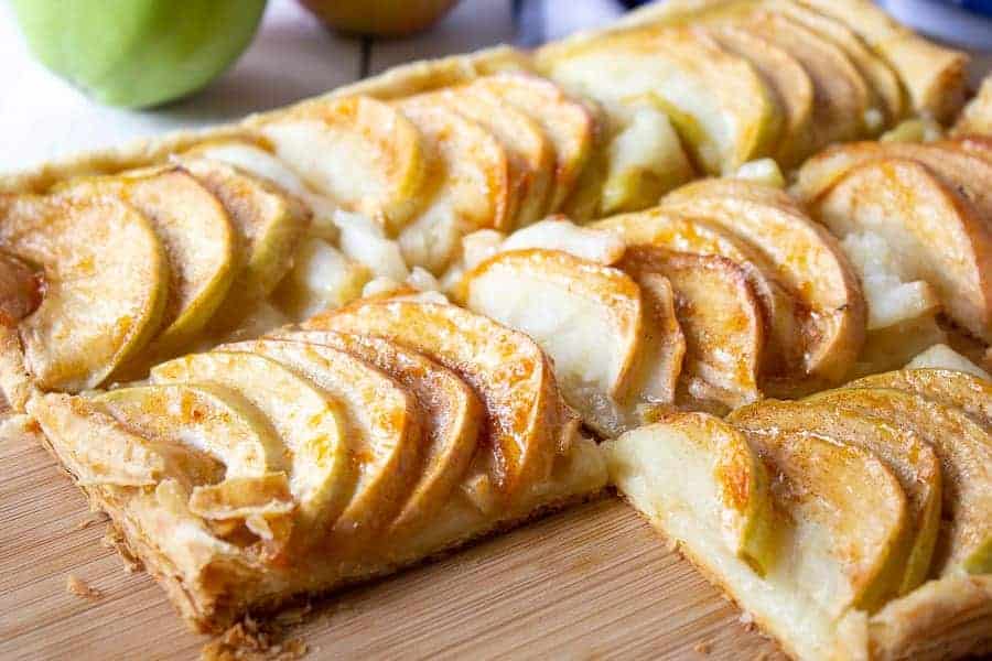 Apple tart on a wooden chopping board.