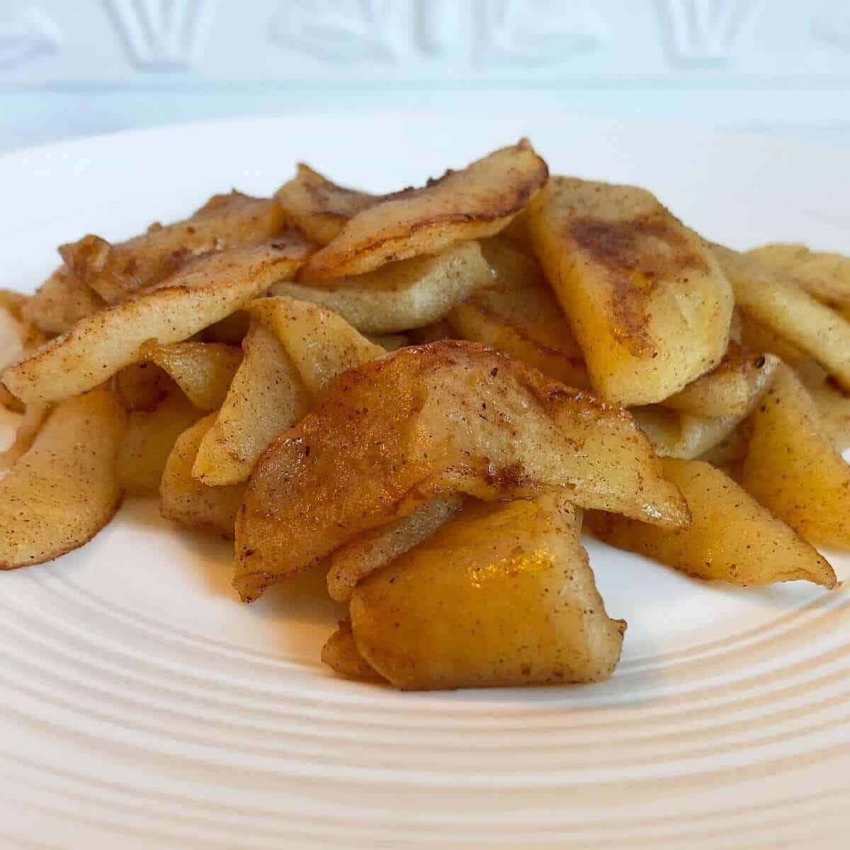 Sautéed cinnamon apples in a plate.