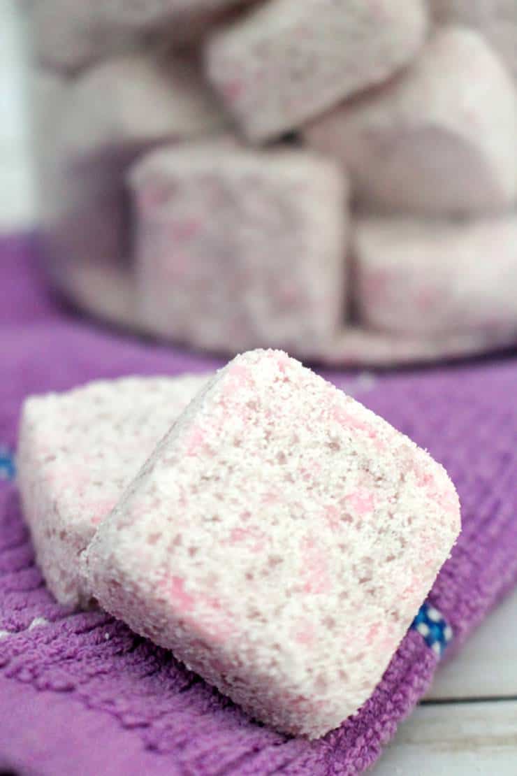 Laundry detergent tabs on a purple towel.