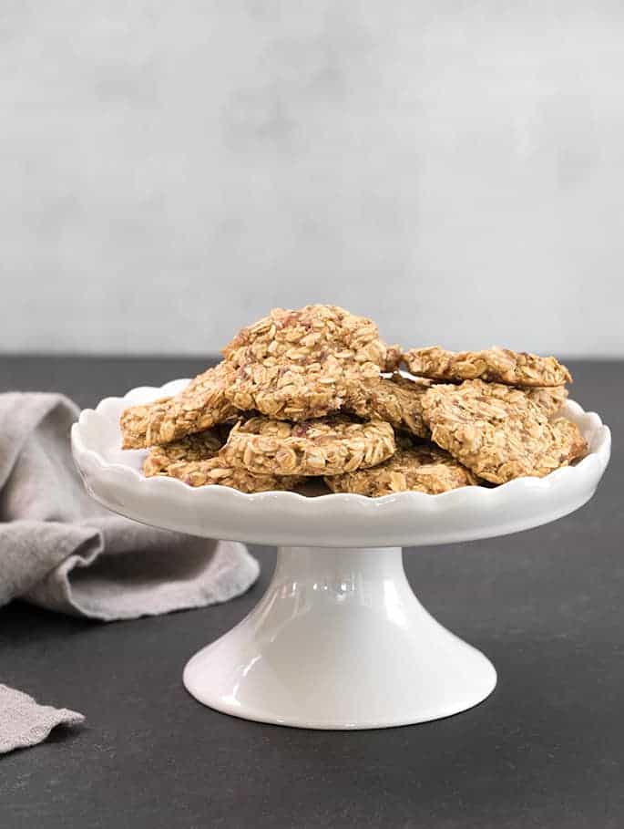 3-ingredient oatmeal cookies on a white pedestal display next to a napkin.