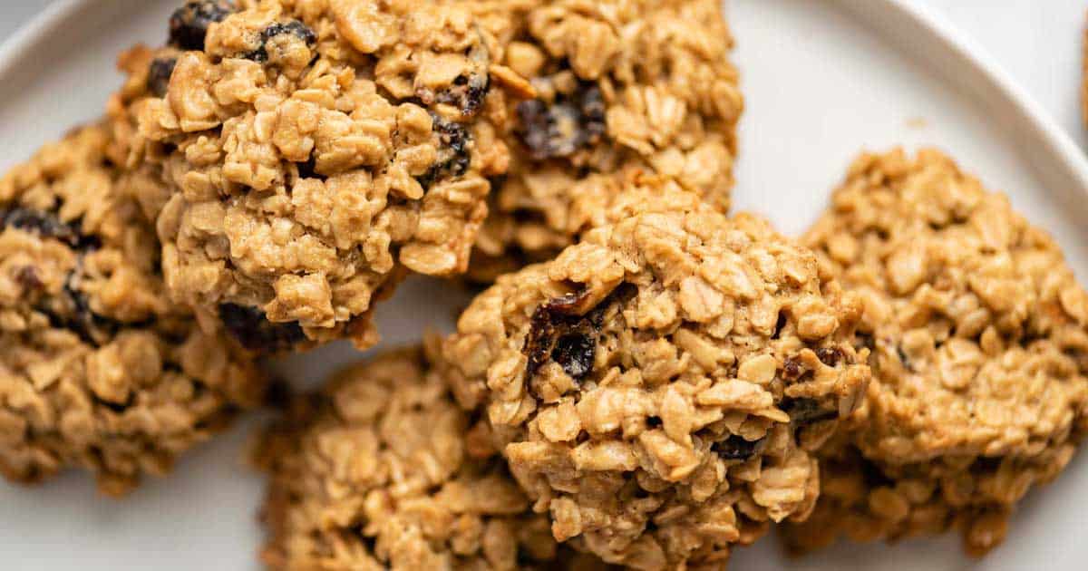 Oatmeal raisin cookies on a white plate.