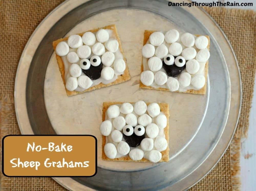 Three sheep graham snacks on a plate with burlap background.