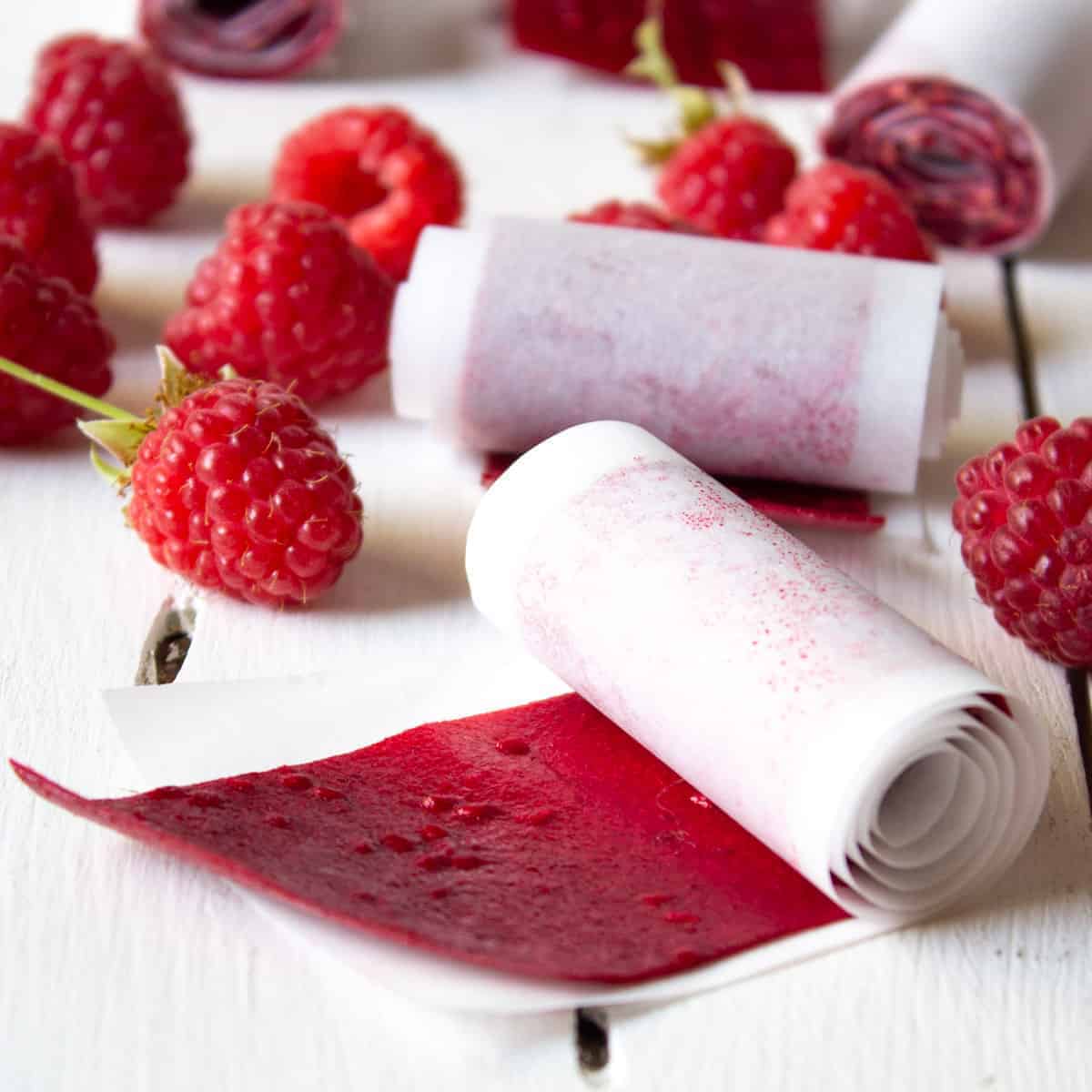 Raspberry fruit roll up with fresh raspberries.
