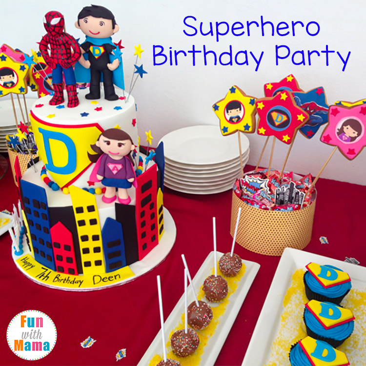 Superhero birthday party snack table with a two-layer cake having spiderman and boy hero on top and girl hero on the side. Cupcakes and cakepops next to the cake.
