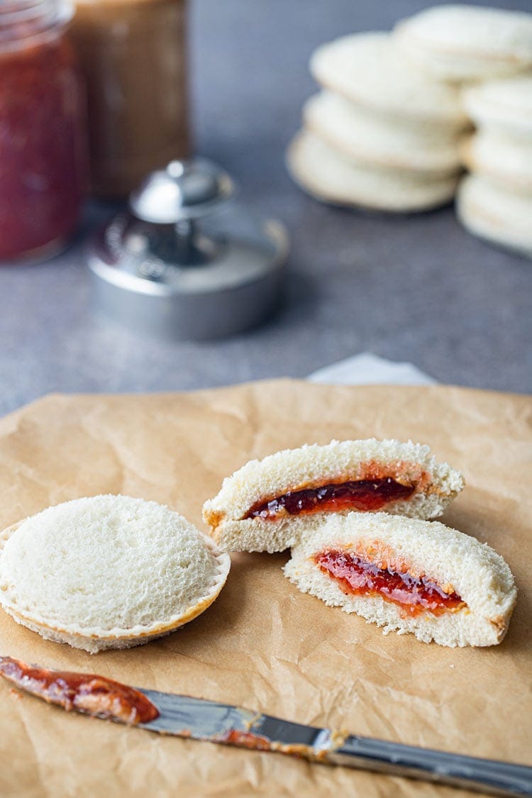 Homemade uncrustables peanut butter and jelly on brown paper bag.