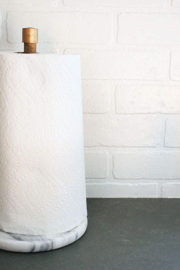 A paper towel in a holder with white background.