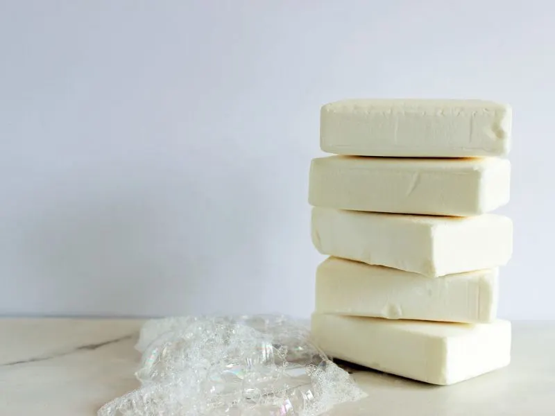 A stack of white soap on a white table.