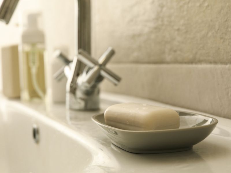 A soap dish in a bathroom sink.