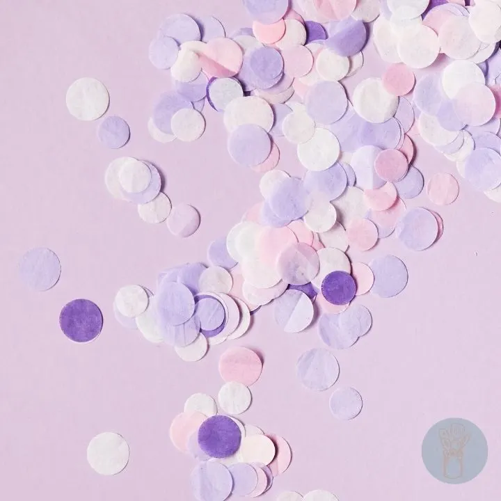 White, violet, purple and pink bath confetti with purple background.