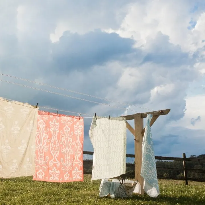 Clean linen hanging on clothes line under the cloudy sky.