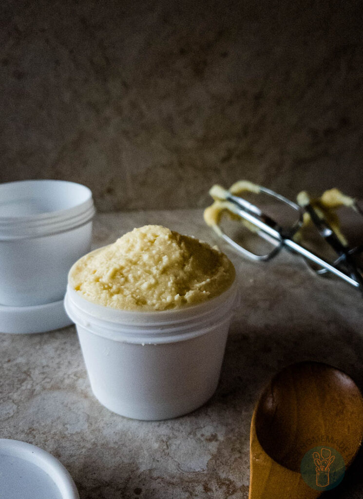 Beard butter in white container without lid next to an empty white container.