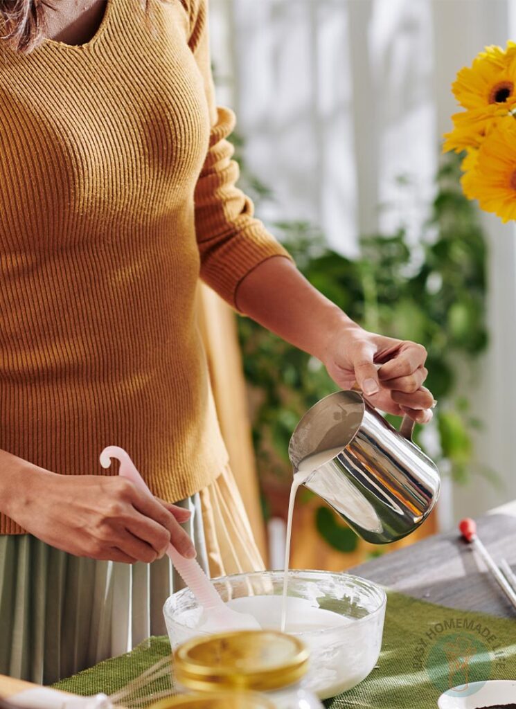 A woman mixing turmeric and honey soap ingredients.