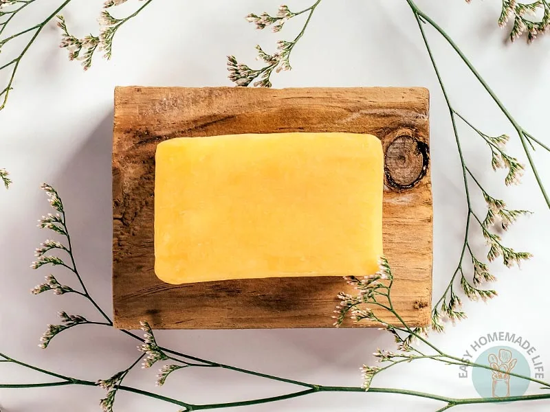 A bar of unwrapped turmeric soap.