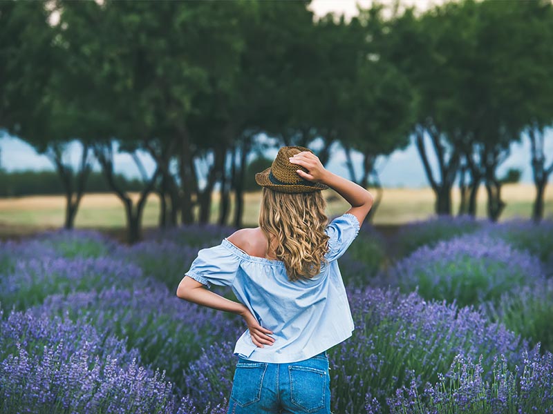 A woman standing on a lavender field.