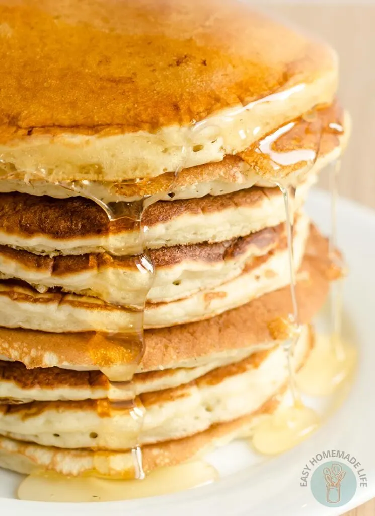 A stack of copycat McDonald's pancake with syrup in a white plate.