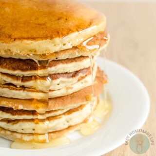 A stack of copycat McDonald's pancake with dripping pancake syrup in a white plate.