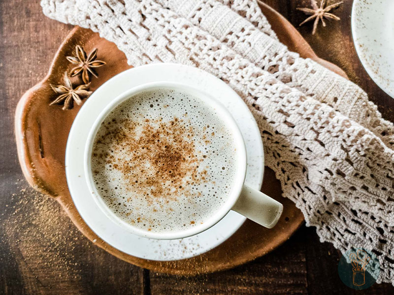 Chocolate chai tea in teacup next to lace napkin.