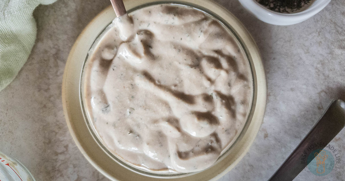 McDonald’s Breakfast Sauce Recipe in a glass bowl on a saucer with a copper spoon.