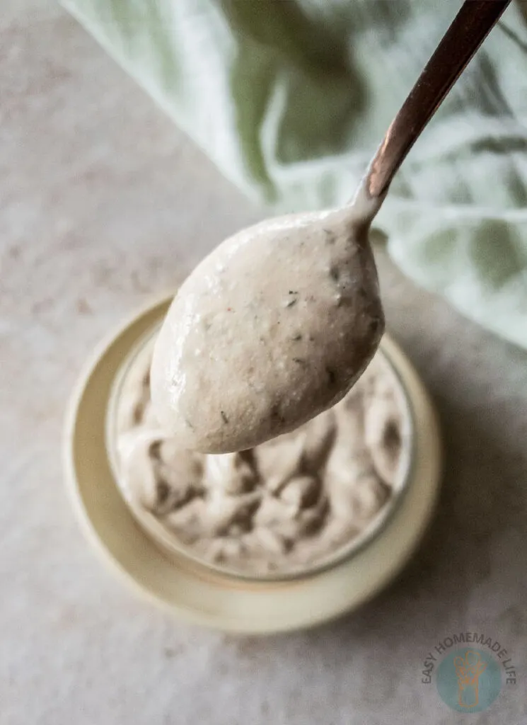 A spoonful of McDonald's breakfast sauce above a bowl of similar sauce.