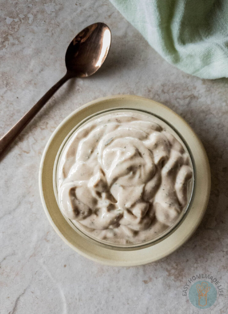 A copycat bowl of McDonald's breakfast sauce next to a metal spoon.