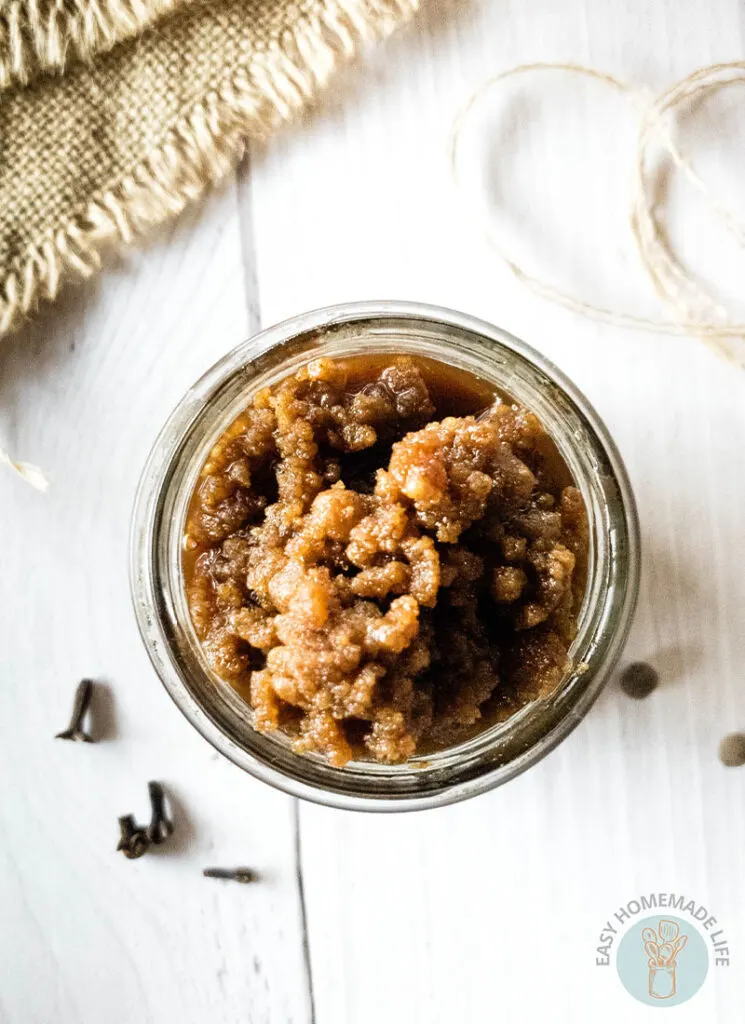 A jar of pumpkin pie spice facial scrub without the lid.