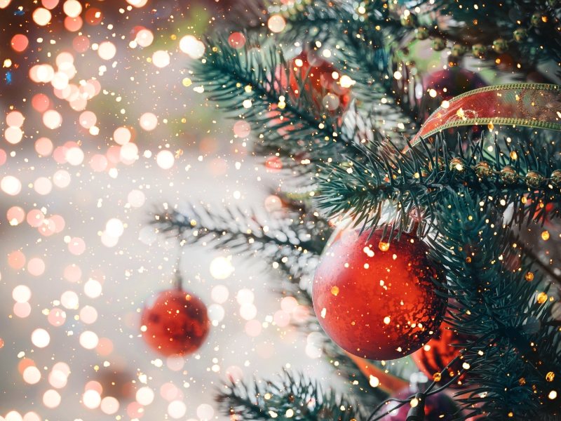 Christmas tree with red ribbon and red Christmas balls.