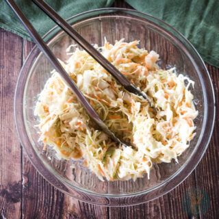 Copycat popeyes coleslaw dressing in a glass bowl ready to be served.