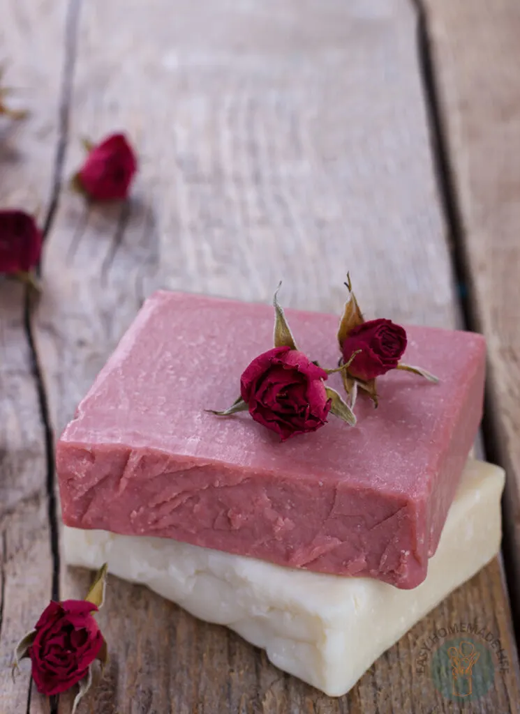 A bar of pink soap with red roses on top.