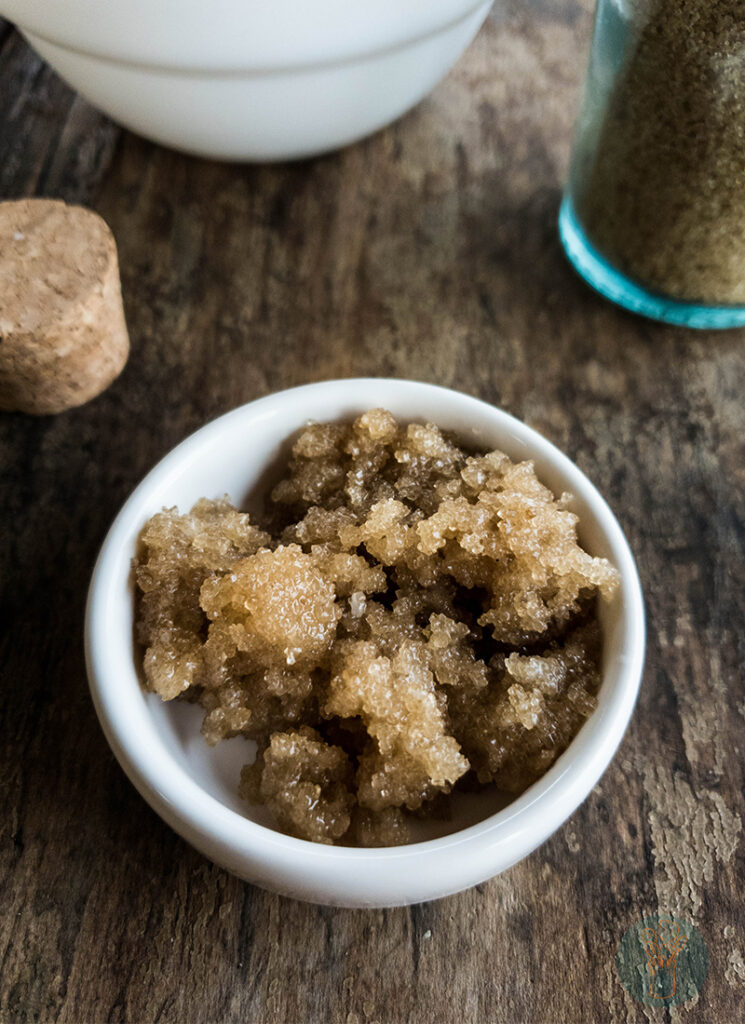 Sugar in a bowl on a wooden table.