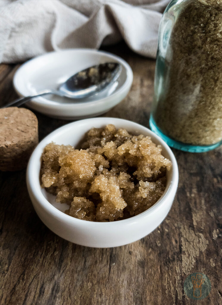 A bowl of brown sugar with a spoon next to it.