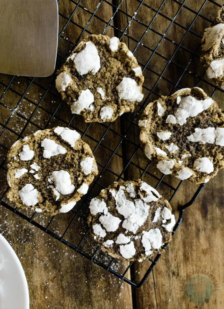 Cookies with powdered sugar on a cooling rack.