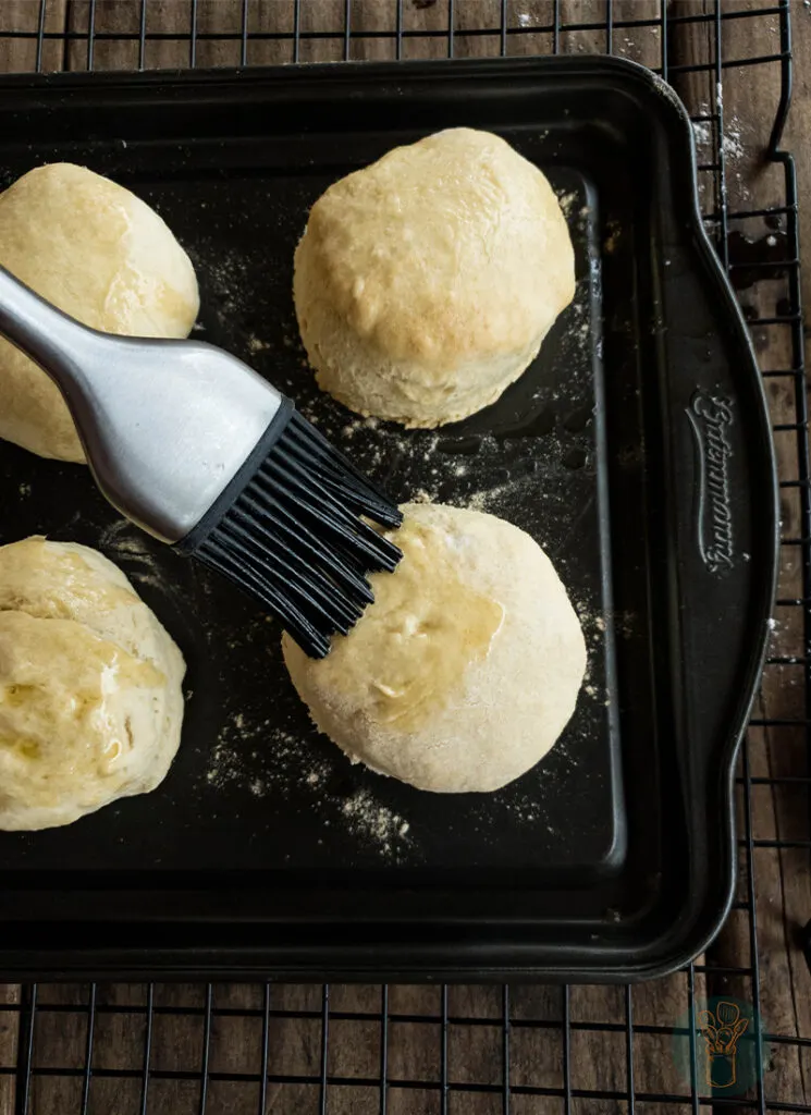 Biscuits on a baking sheet with a spatula.