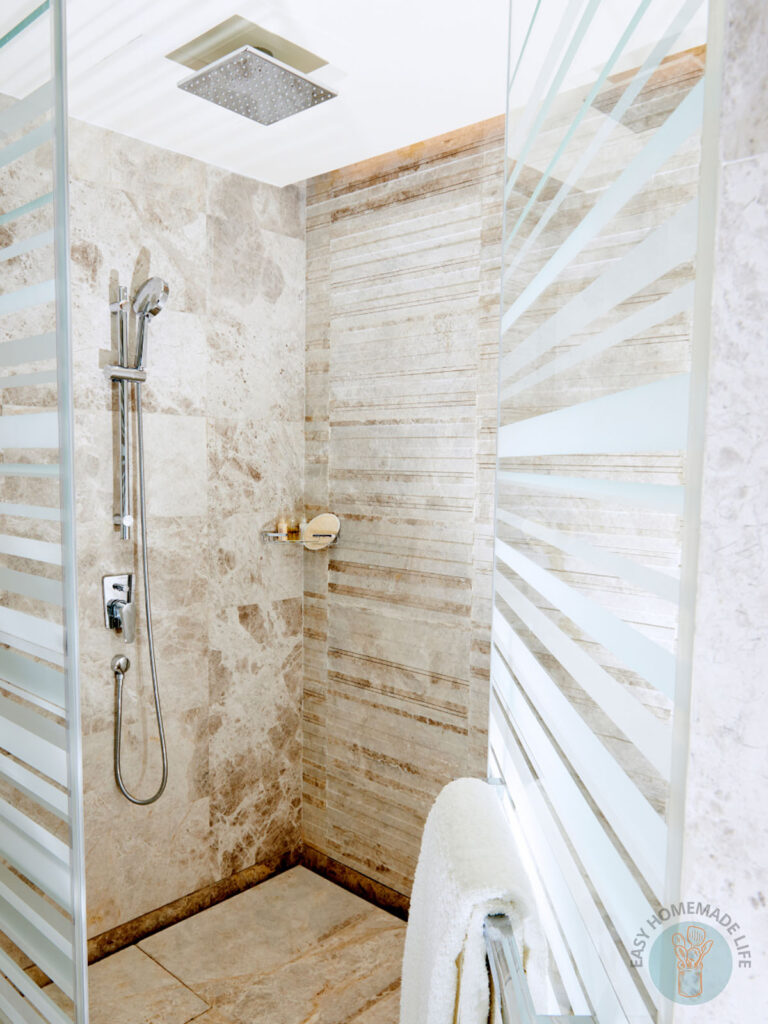 Shower room with opened glass door.