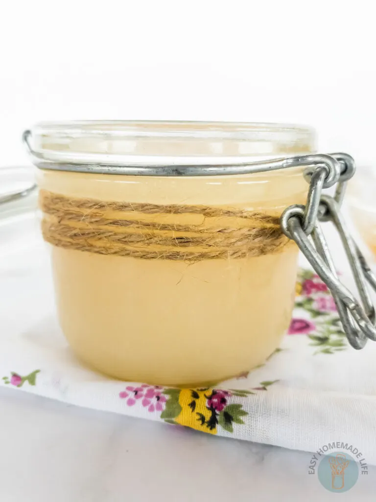 homemade goat milk and sugar body scrub in a sealed glass jar with twine wrapping