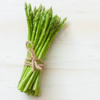 A bunch of fresh asparagus tied with twine.