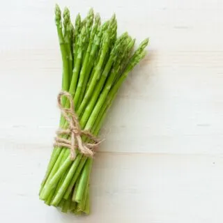 A bunch of fresh asparagus tied with twine.