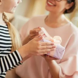 daughter giving a gift to her mom