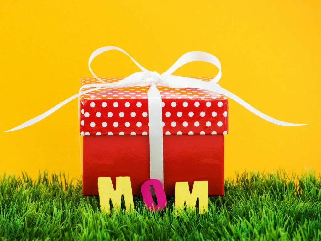 red gift box white bow with letters spelling MOM